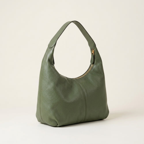 Green handbag on a light beige background